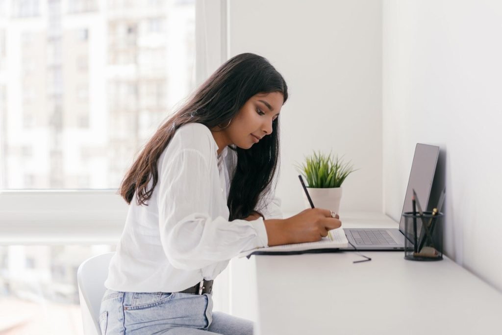 Woman working and writing a note