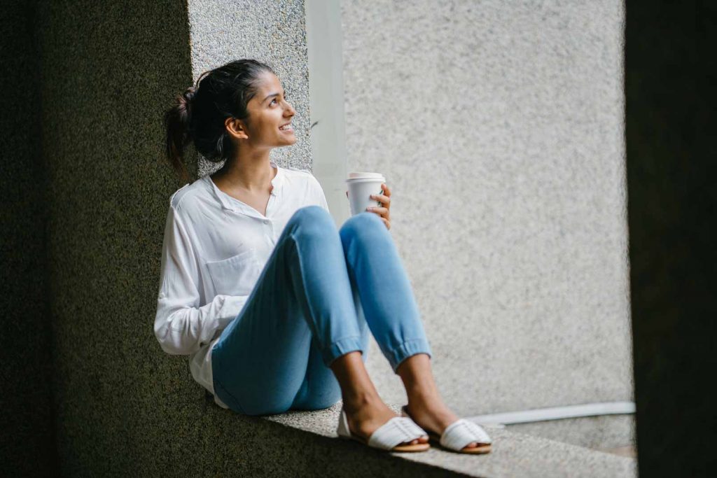 Happy woman looking up at the sky