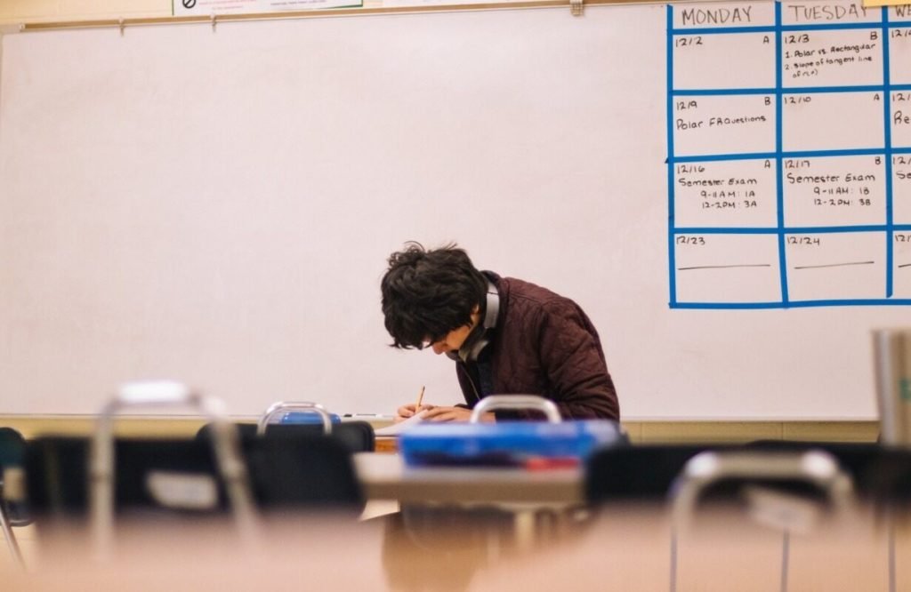 Man-writing-on-a-table