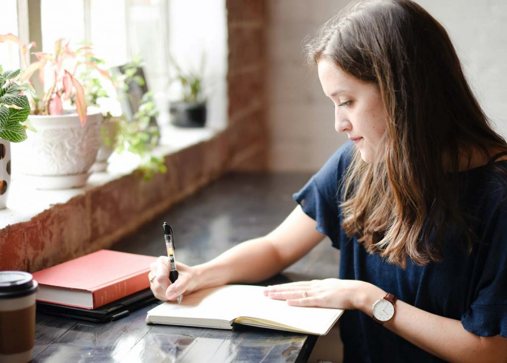 Woman writing in journal - Immunity to Change