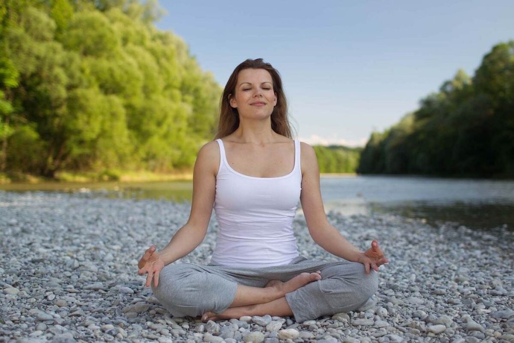 Woman practicing lessons learned from Meditation University's Meditation Teacher Training