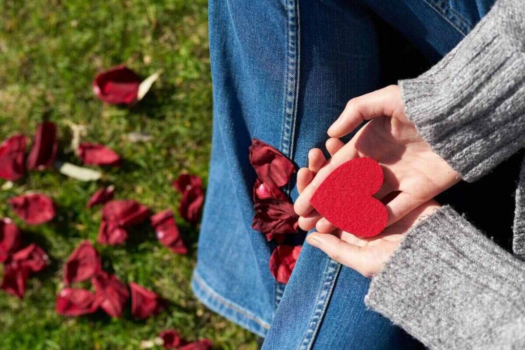 Person holding heart cutouts