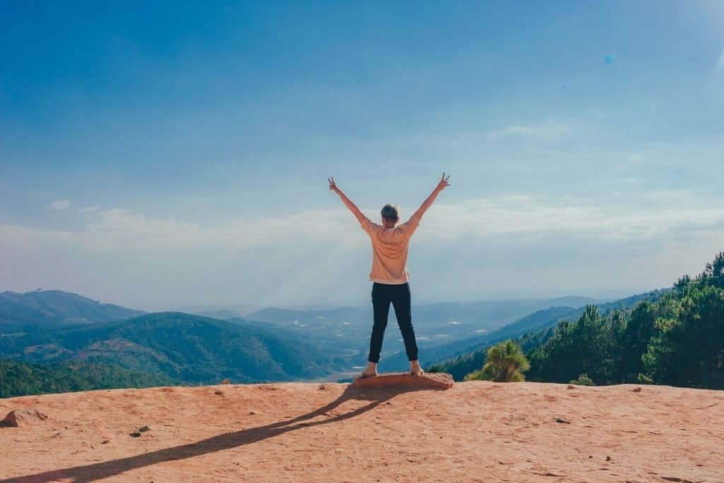 Woman standing over the edge of a cliff