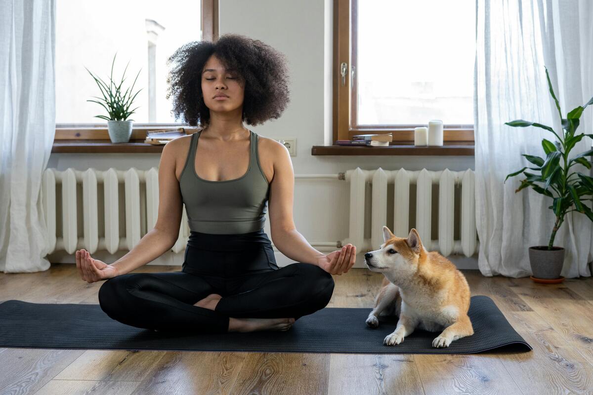 Woman meditating with dog