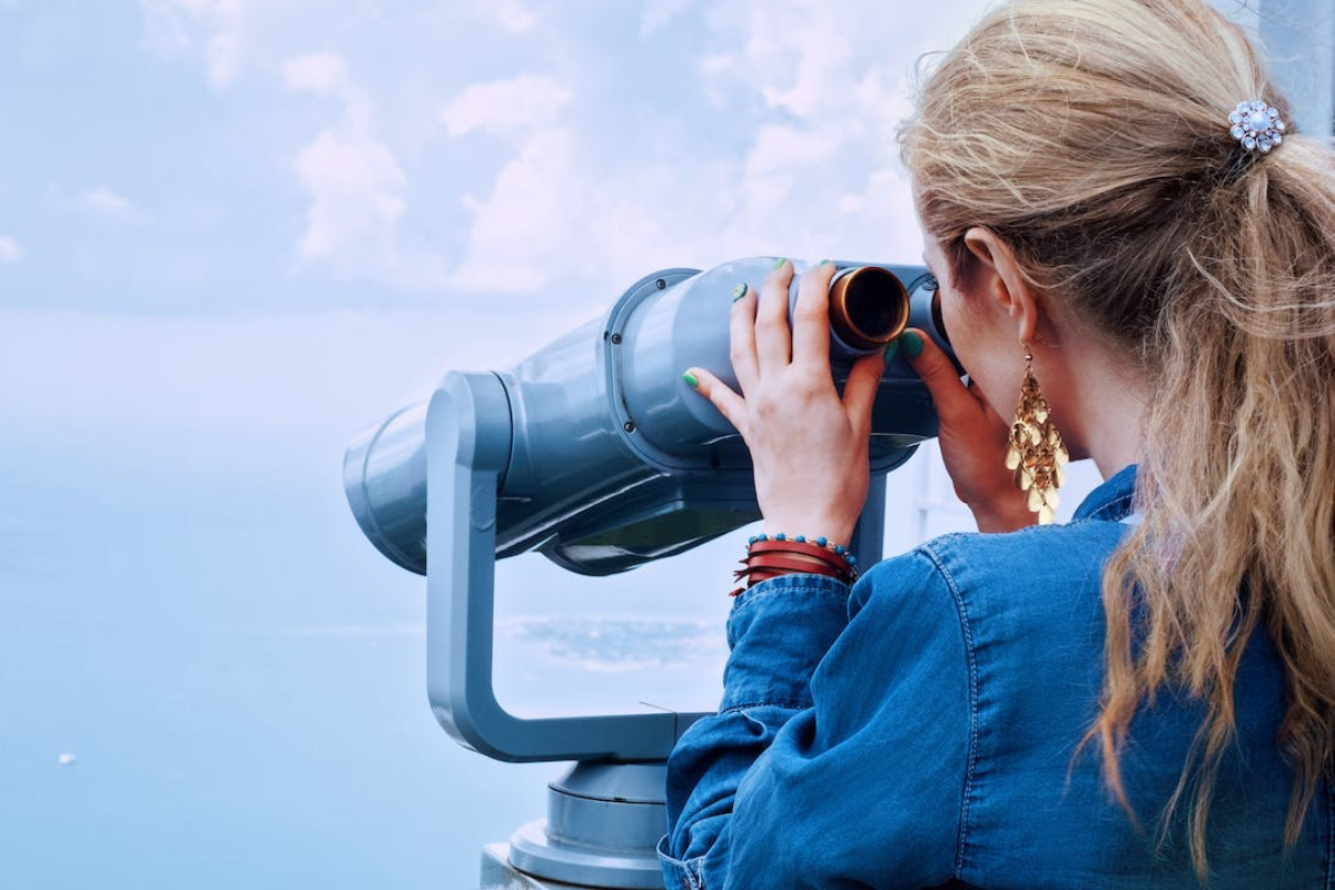 Woman looking through telescope - how to find your coaching niche