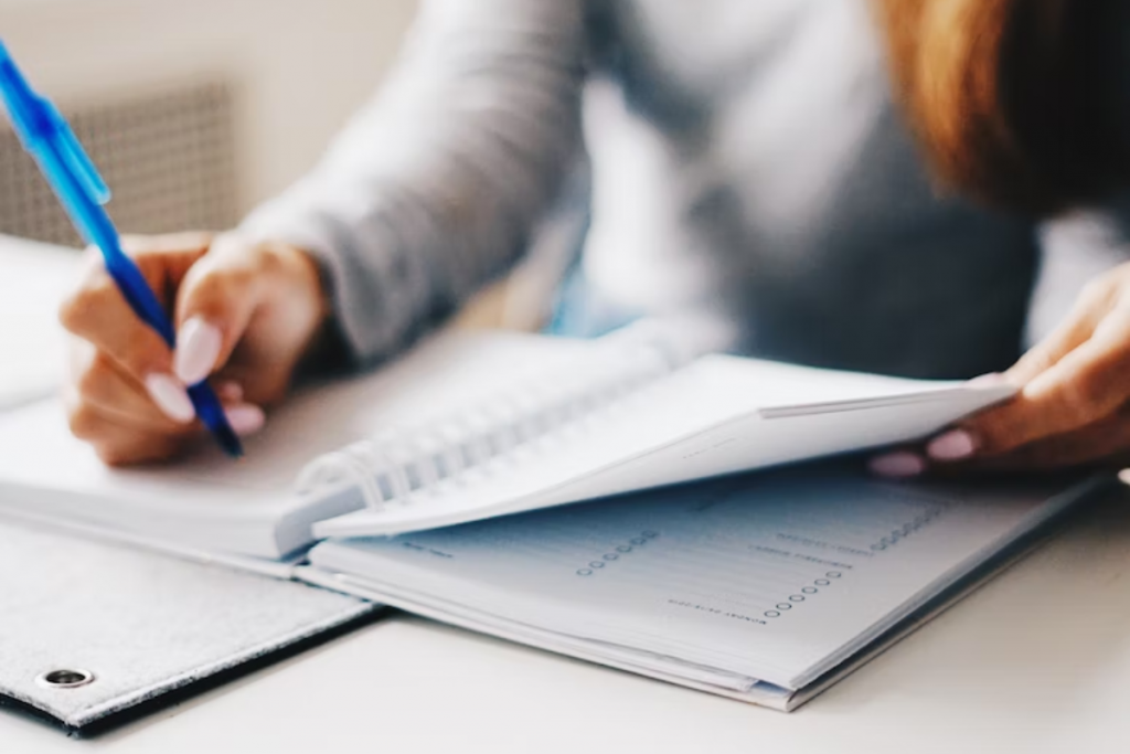 Woman writing on notebook