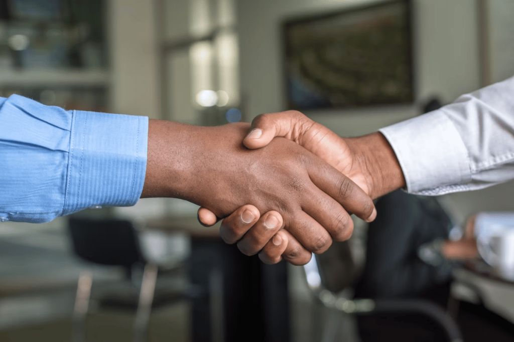 Two people shaking hands - Networking Your Way to a Better Coaching Business – in 4 Steps