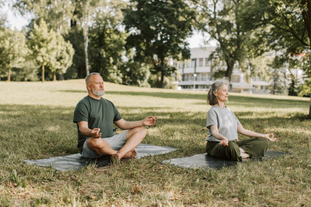 Middle aged people doing yoga in the presence of each other