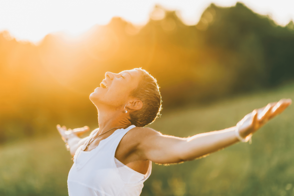 Person looking up at sky with arms stretched - what is the true meaning of spirituality